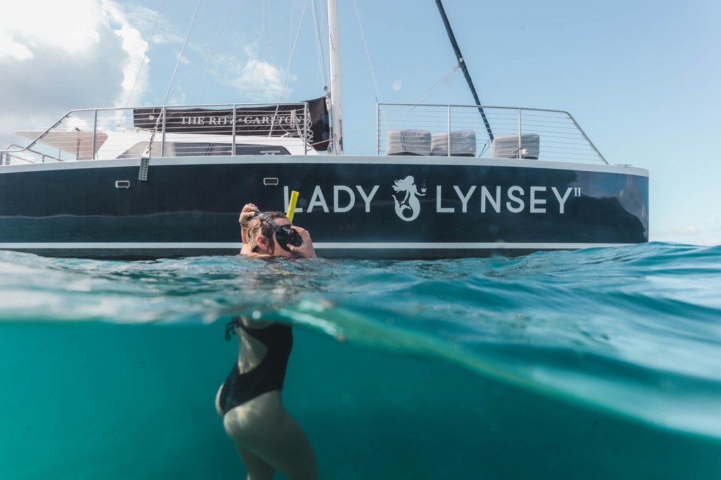 Person swims underwater near a boat labeled 'Lady Lynsey.'